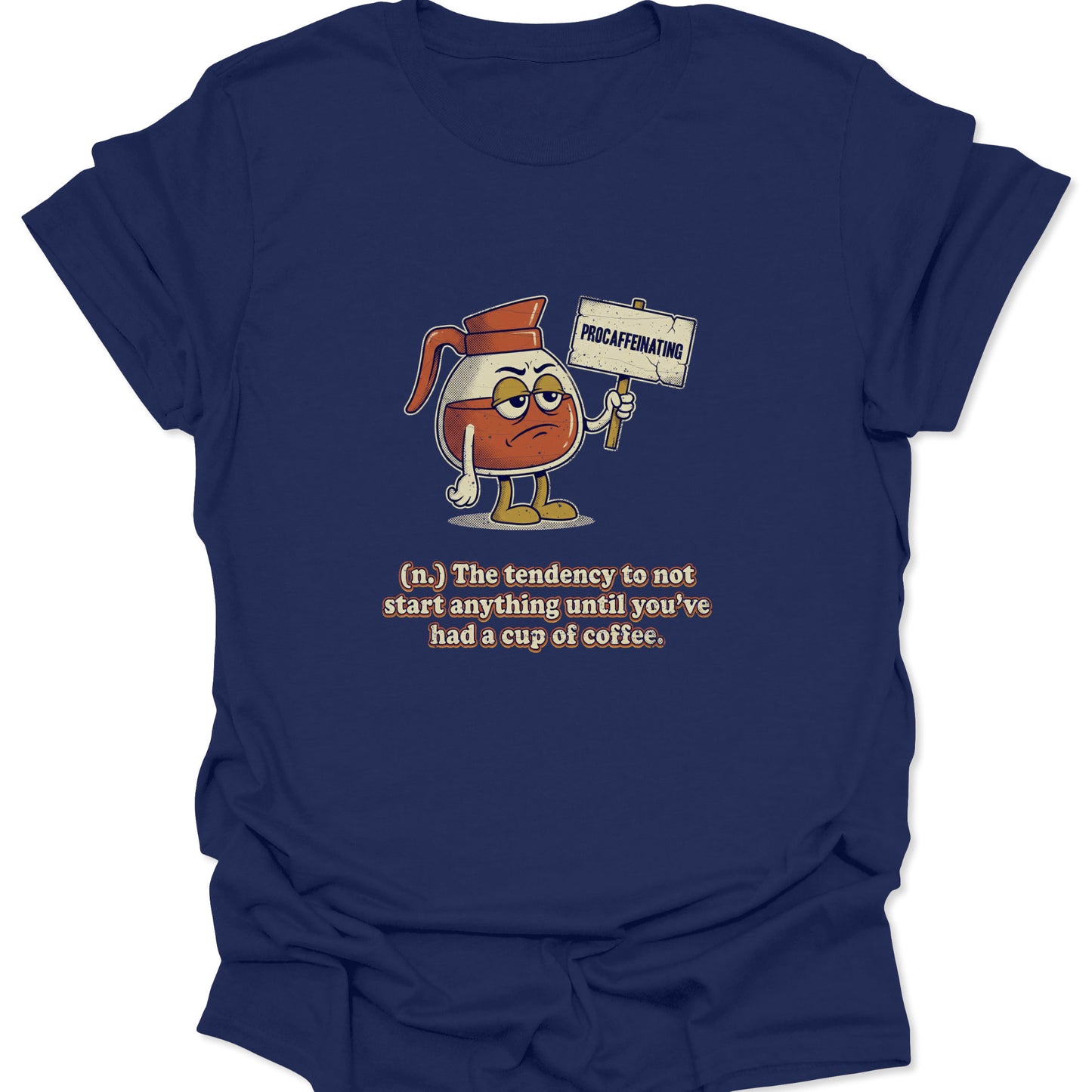 A navy blue graphic t-shirt featuring a cartoon coffee carafe with a grumpy face holding a "PROCAFFEINATING" sign above a dictionary-style definition.