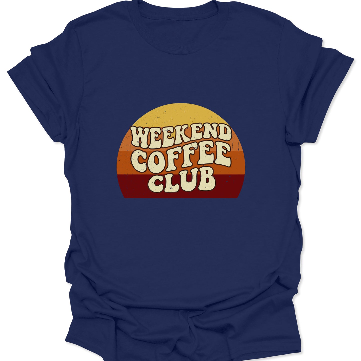Graphic tee on a navy blue fabric background featuring a retro sunset semi-circle with "Weekend Coffee Club" text in a cream-colored, bubbly 70s font.