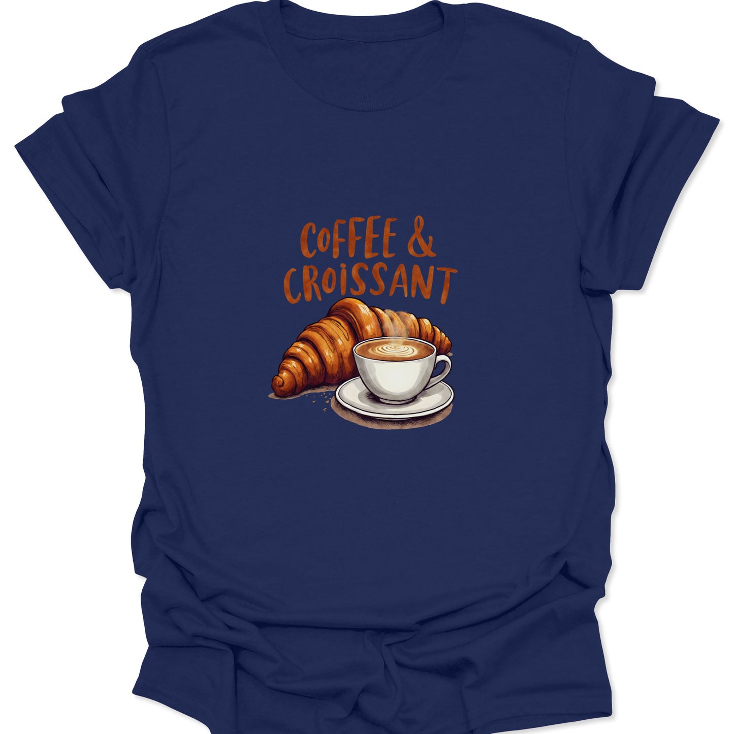 Navy blue tee with a detailed graphic image of a small white coffee cup filled with a latte and a large, golden croissant, over a wooden table background print.