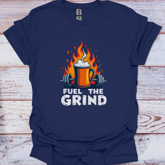 Navy blue t-shirt with a graphic of a mug with flames, weights, and 'Fuel the Grind' text on a wooden surface.