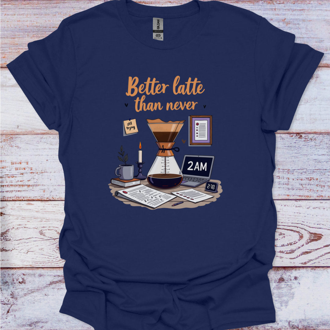 Navy blue t-shirt with coffee-themed graphic and 'Better latte than never' text on a wooden surface.