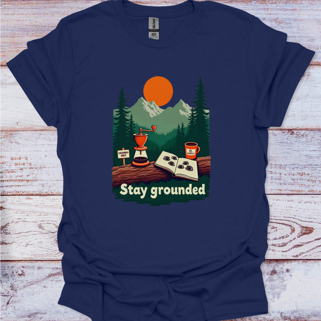 Navy blue t-shirt with a graphic of a coffee grinder, cup, and nature scene on a wooden surface.