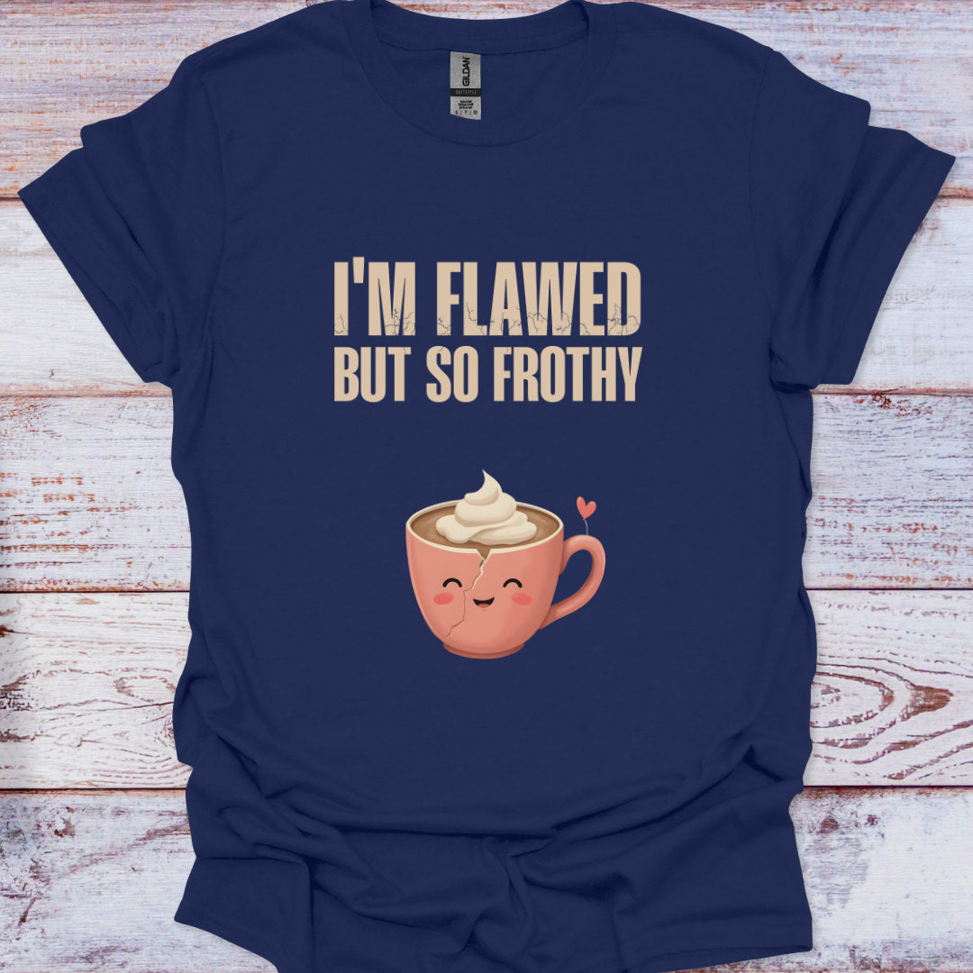 Navy blue t-shirt with a cartoon coffee cup and text 'I'm Flawed But So Frothy' on a wooden surface.