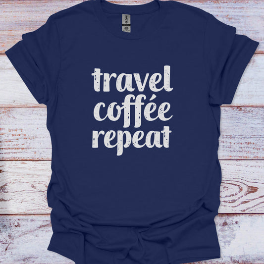 Navy blue t-shirt with 'travel coffee repeat' text on a wooden surface