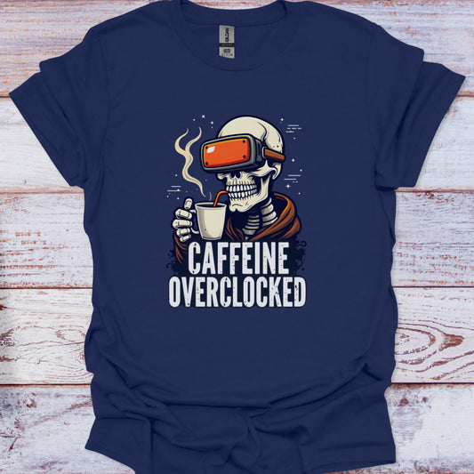 Navy blue t-shirt with a skeleton wearing VR goggles and holding a coffee cup, text 'CAFFEINE OVERCLOCKED' on a wooden surface.