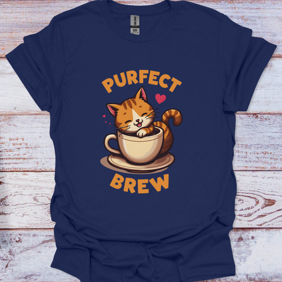 Navy blue t-shirt with a cat in a coffee cup graphic and 'PURFECT BREW' text on a wooden surface.