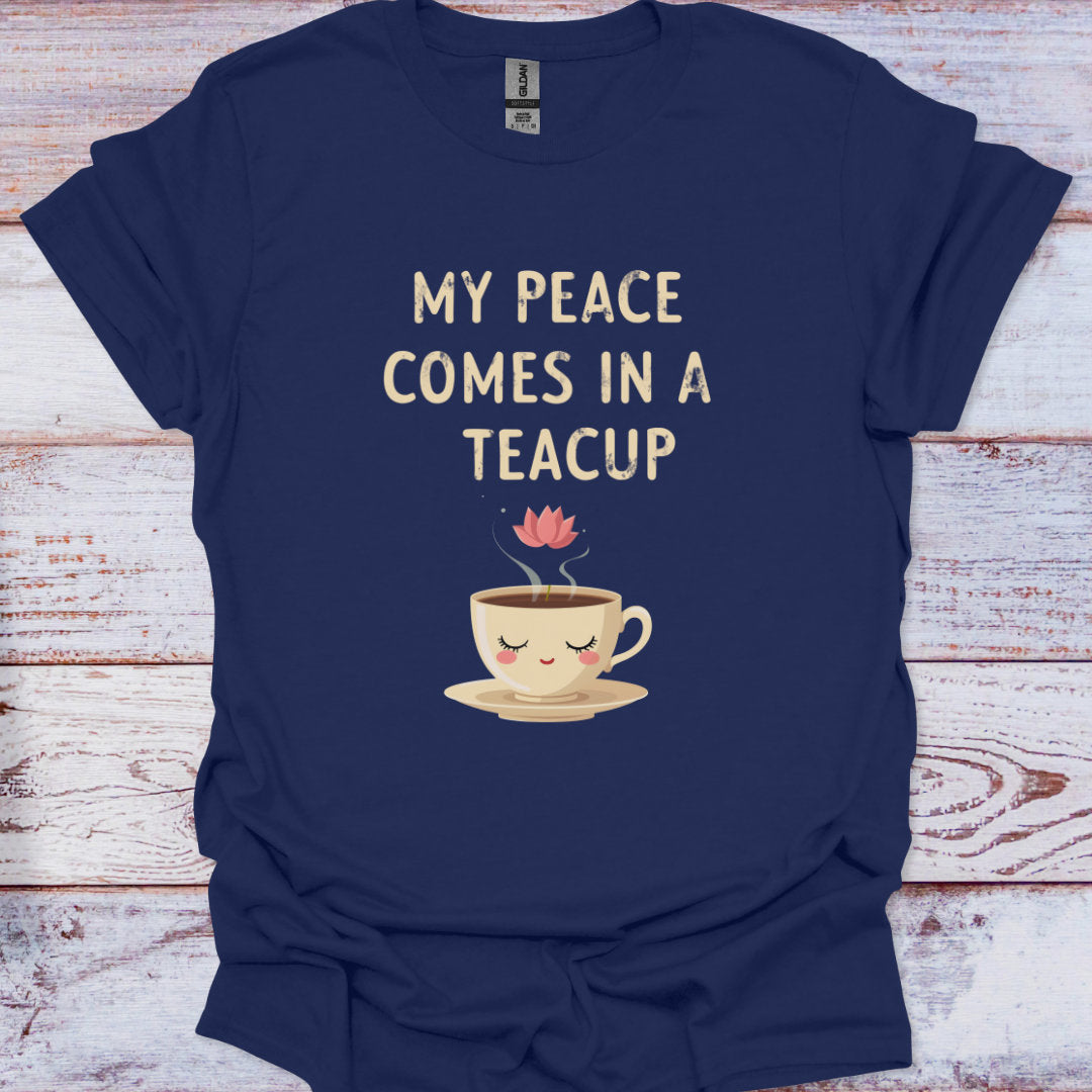 Navy blue t-shirt with a teacup graphic and text on a wooden surface
