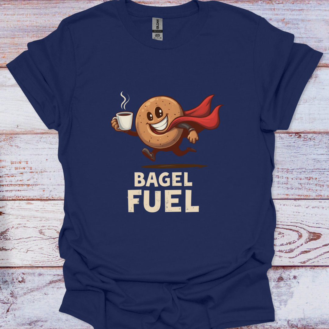 Navy blue t-shirt with a bagel character holding a coffee cup and text 'Bagel Fuel' on a wooden surface.