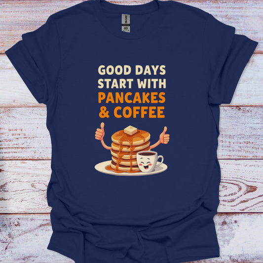 Navy blue t-shirt with 'Good days start with pancakes & coffee' design on a wooden surface