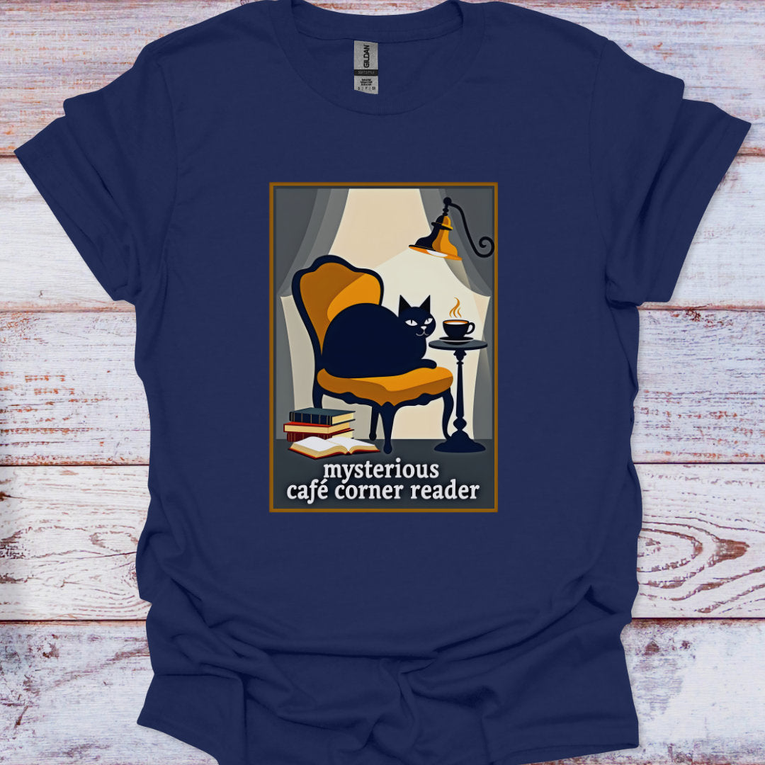 Navy blue t-shirt with a graphic of a cat in a cafe corner and text 'mysterious cafe corner reader' on a wooden surface.