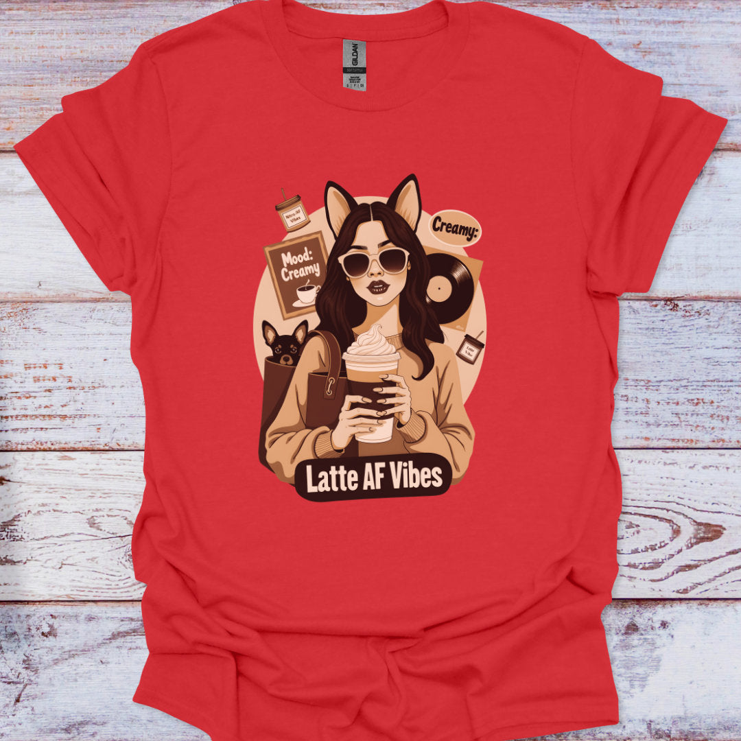 Red t-shirt with a graphic of a woman holding a coffee cup and text 'Latte AF Vibes' on a wooden surface.