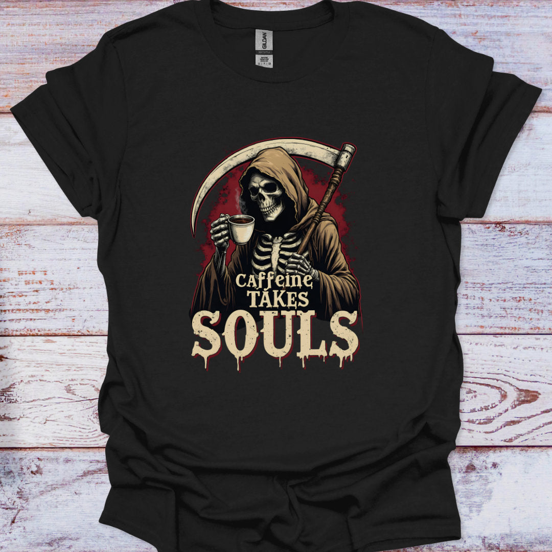 Black t-shirt with a skeleton holding a coffee cup and 'Caffeine Takes Souls' text on a wooden surface.
