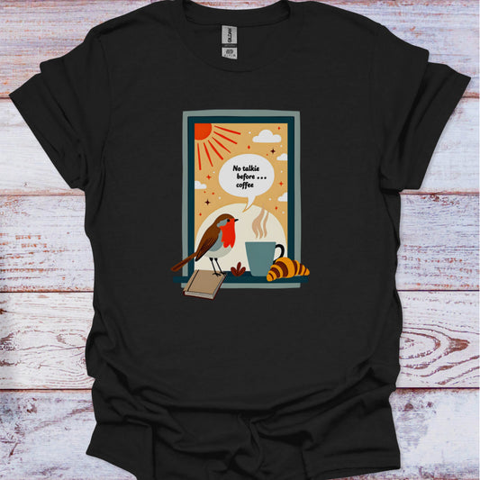 Black t-shirt with a graphic design featuring a bird, coffee cup, and book on a wooden surface.