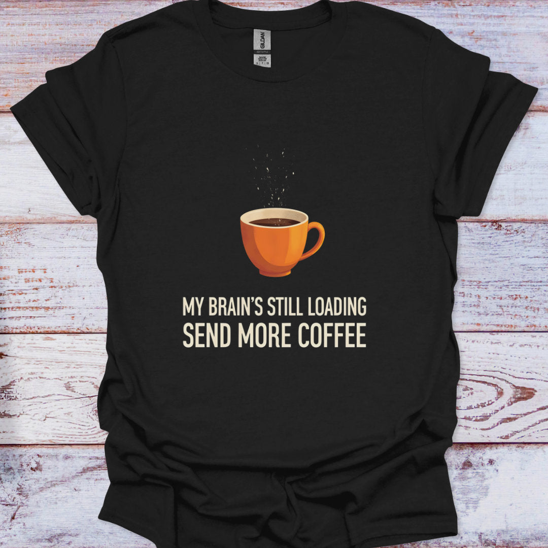 Black t-shirt with a coffee cup graphic and text on a wooden surface