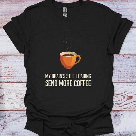 Black t-shirt with a coffee cup graphic and text on a wooden surface