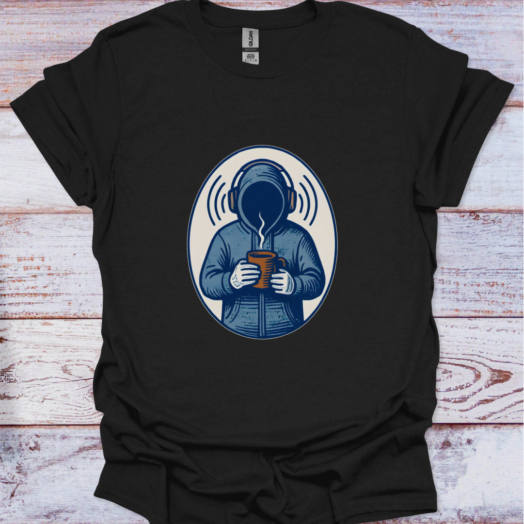 Black t-shirt with a graphic of a person in headphones holding a mug on a wooden surface