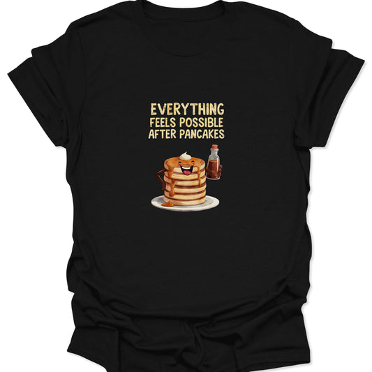 Black t-shirt featuring a cartoon pancake stack pouring syrup with text Everything Feels Possible After Pancakes.
