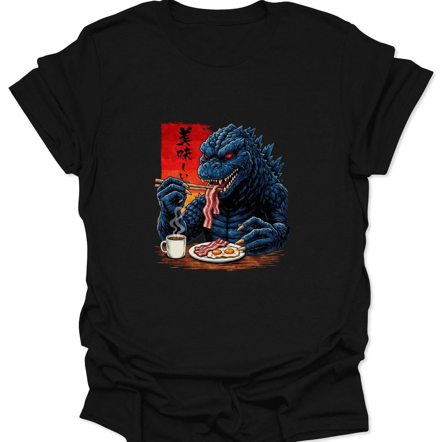 Graphic tee on a black fabric featuring a blue scaly monster eating breakfast with chopsticks and a mug of coffee.