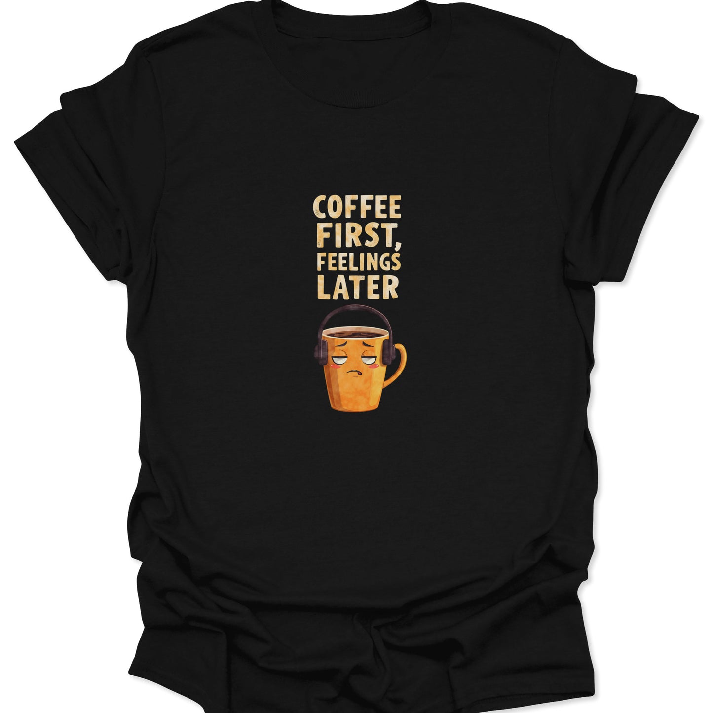 Black t-shirt featuring grumpy mug with headphones and "Coffee First, Feelings Later" text, funny introvert style.