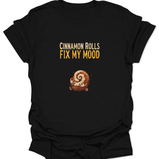 Funny cinnamon roll graphic tee with text Cinnamon Rolls Fix My Mood on a Black shirt.