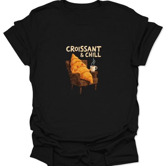 Graphic T-shirt featuring a relaxed, cartoon croissant character chilling in a brown armchair with a coffee mug, text reads "CROISSANT & CHILL" on a black background.