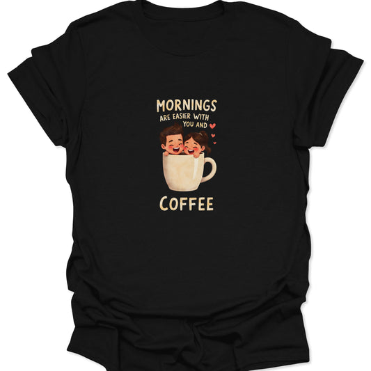 Close-up of black t-shirt featuring a cartoon couple smiling inside a coffee mug with the text "Mornings Are Easier With You And Coffee." Romantic, witty coffee apparel.