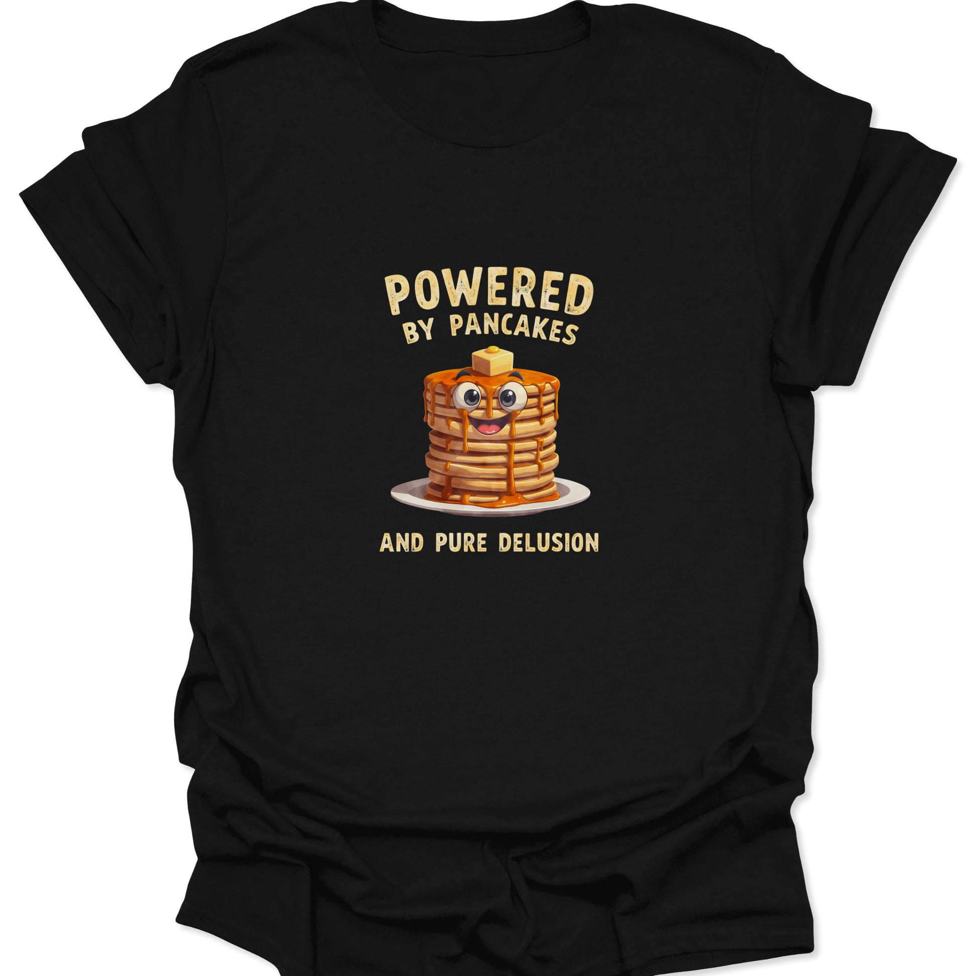 Funny graphic tee on Black fabric showing a cartoon pancake stack with googly eyes and text Powered By Pancakes And Pure Delusion.