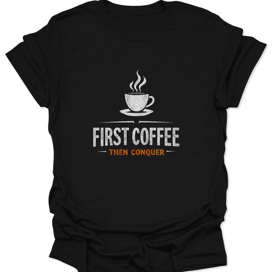 High-contrast white and orange graphic tee featuring a coffee cup and the motivational phrase "First Coffee Then Conquer" on a solid black fabric.