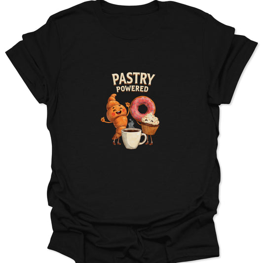 Close-up of black t-shirt with a cartoon graphic of an excited croissant, pink donut, and cupcake standing around a steaming coffee cup with the text "PASTRY POWERED."