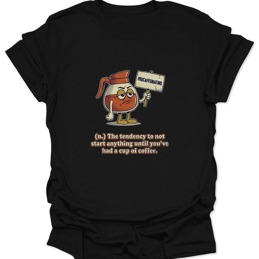 A black graphic t-shirt featuring a cartoon coffee carafe with a grumpy face holding a "PROCAFFEINATING" sign above a dictionary-style definition.
