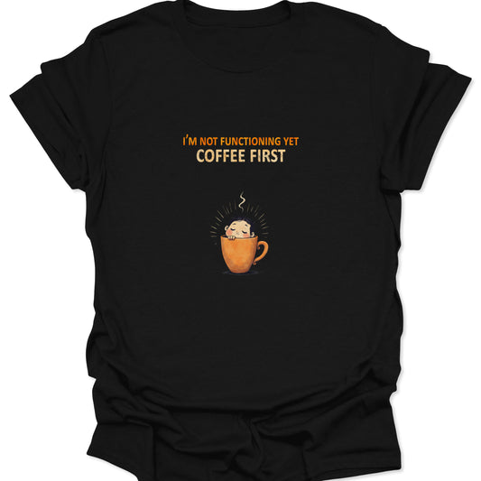 Black t-shirt featuring a sleepy cartoon character inside an orange mug, funny morning quote text.