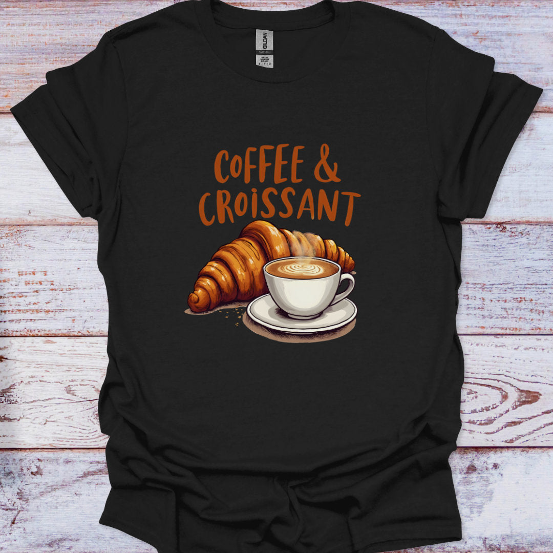 Black t-shirt with 'Coffee & Croissant' design on a wooden surface