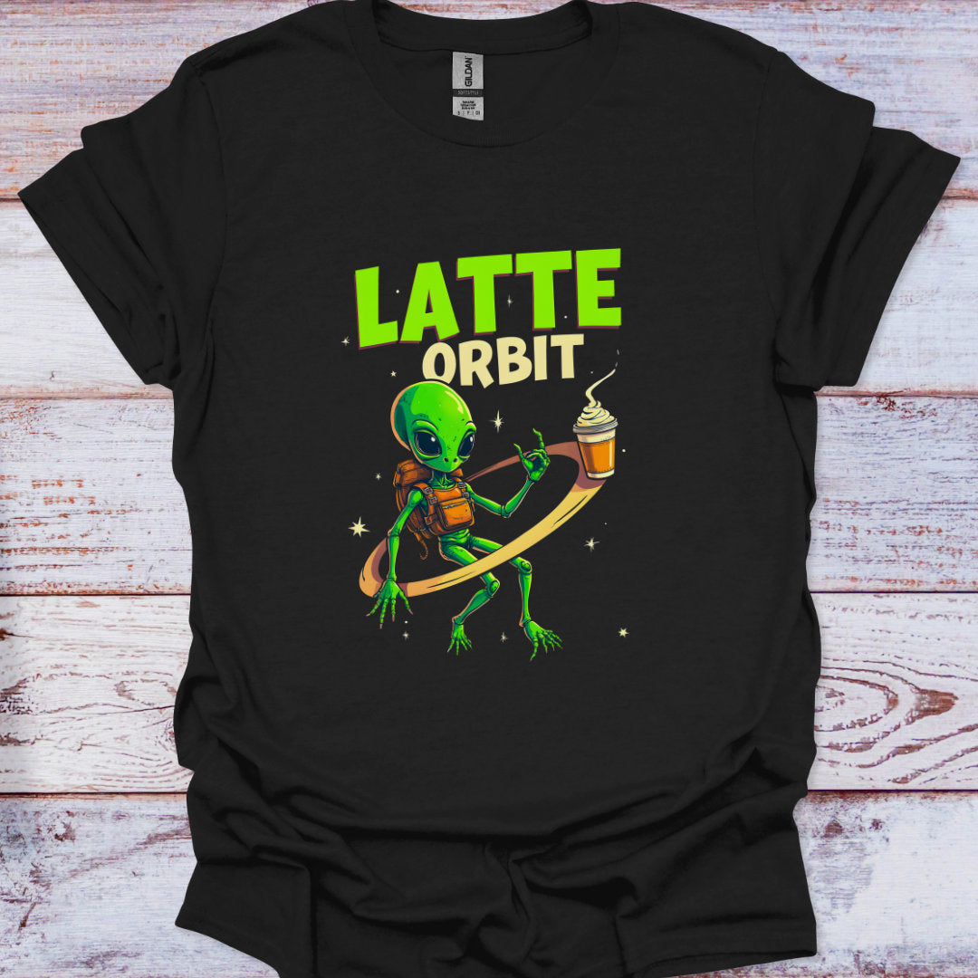 Black t-shirt with a green alien holding a coffee cup and 'Latte Orbit' text on a wooden surface