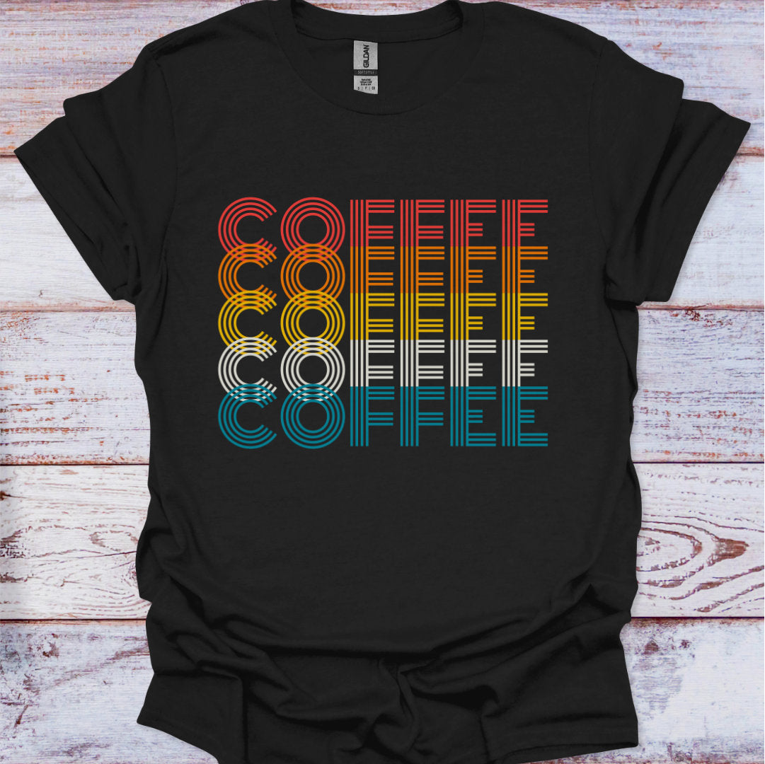 Black t-shirt with colorful 'COFFEE' text design on a wooden surface