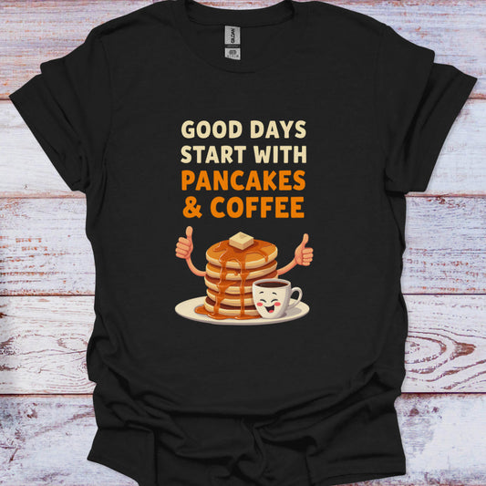 Black t-shirt with 'Good days start with pancakes & coffee' design on a wooden surface