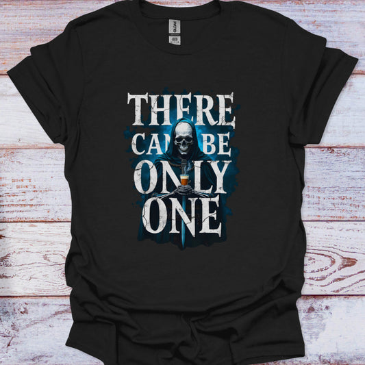 Black t-shirt with a skull graphic and text 'There can be only one' on a wooden surface