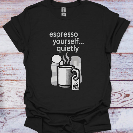 Black t-shirt with a coffee-themed graphic and text on a wooden surface
