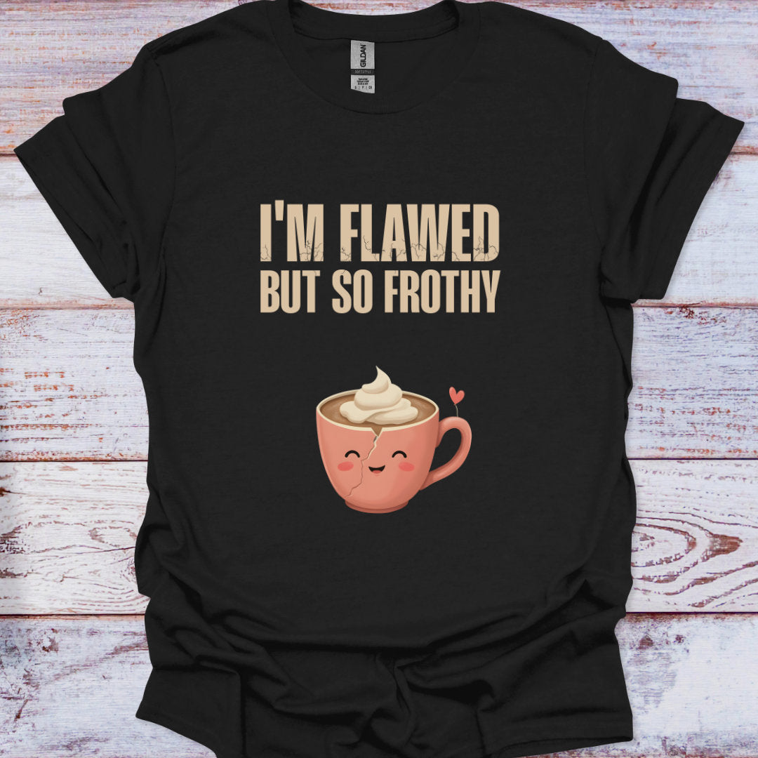 Black t-shirt with a cartoon coffee cup and text 'I'm Flawed But So Frothy' on a wooden surface