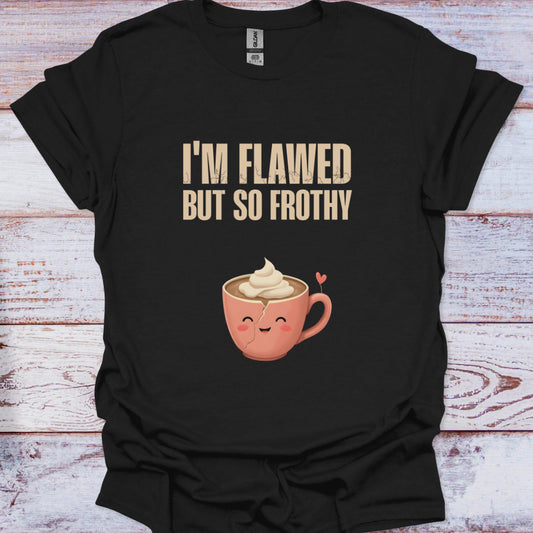 Black t-shirt with a cartoon coffee cup and text 'I'm Flawed But So Frothy' on a wooden surface