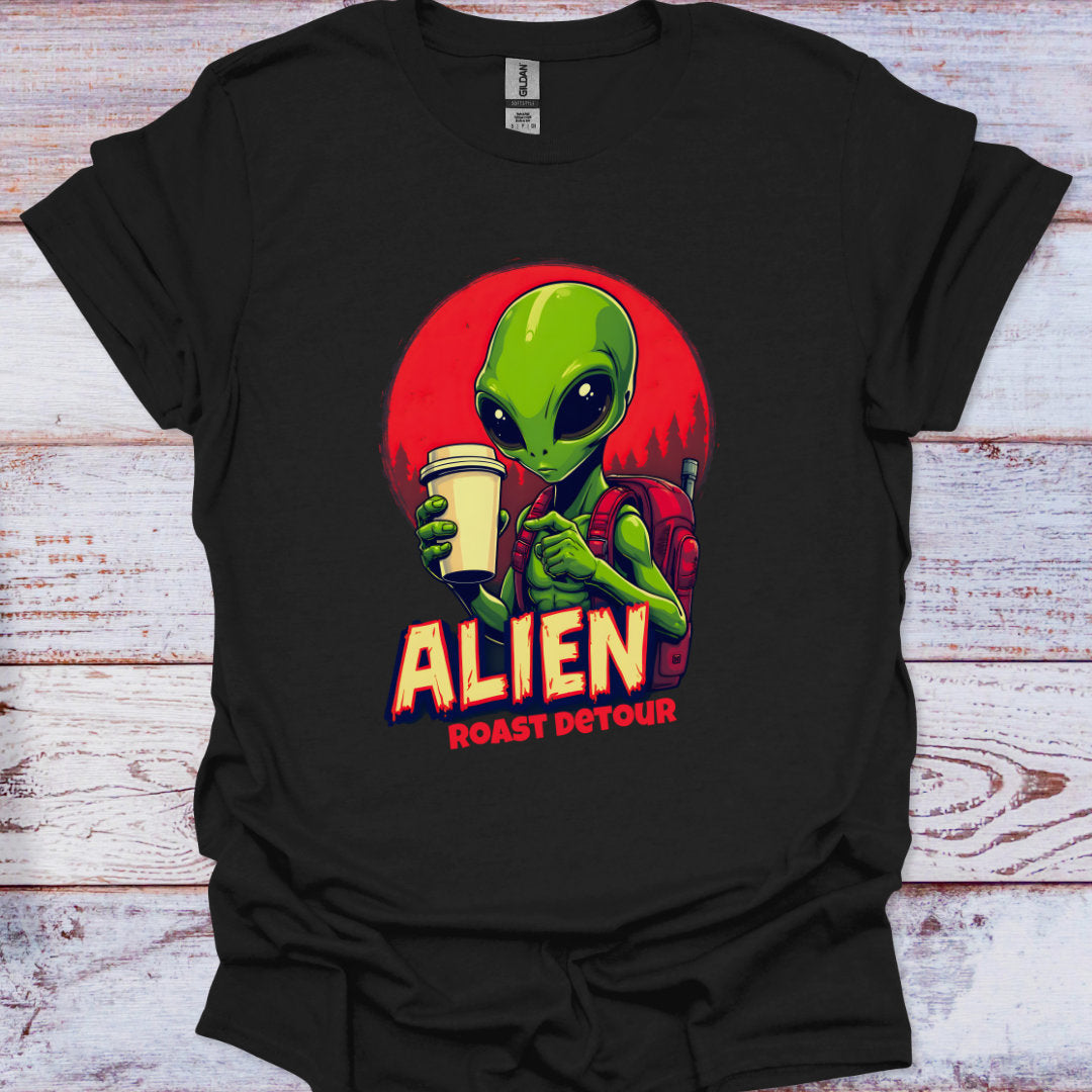 Black t-shirt with an alien graphic holding a coffee cup on a wooden surface