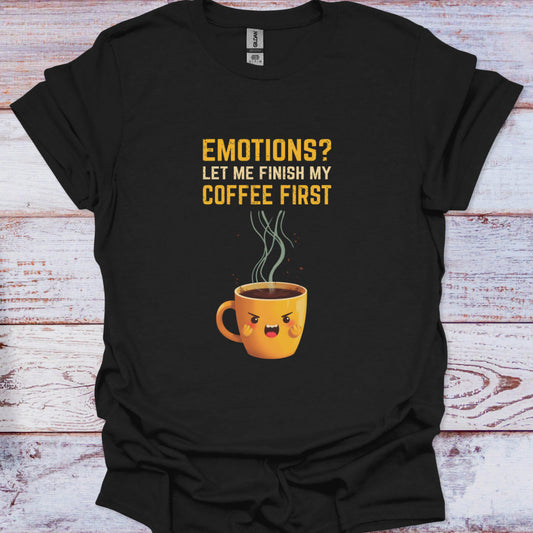 Black t-shirt with a graphic of a coffee cup and text on a wooden surface