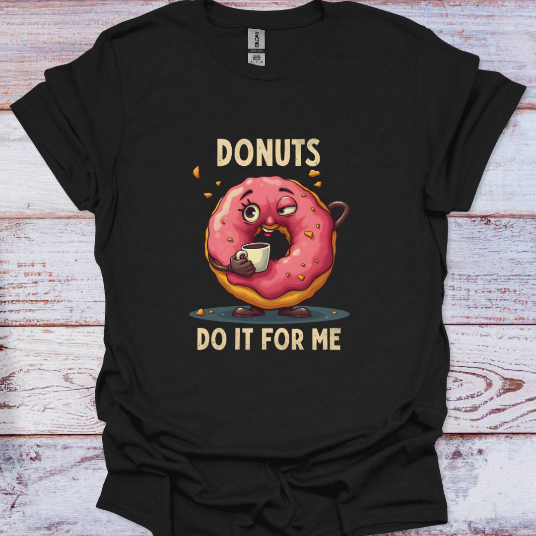 Black t-shirt with a cartoon donut holding a coffee cup and text 'DONUTS DO IT FOR ME' on a wooden surface.