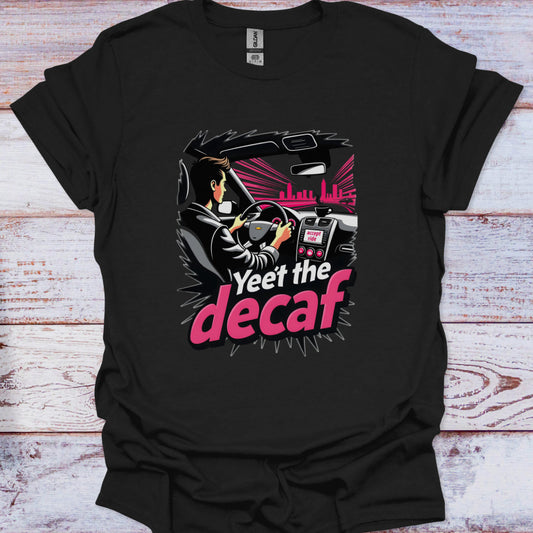 Black t-shirt with a graphic design of a person driving a car and text 'Yeet the decaf' on a wooden surface.