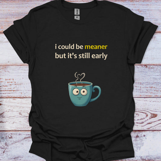 Black t-shirt with a cartoon coffee cup and text on a wooden surface