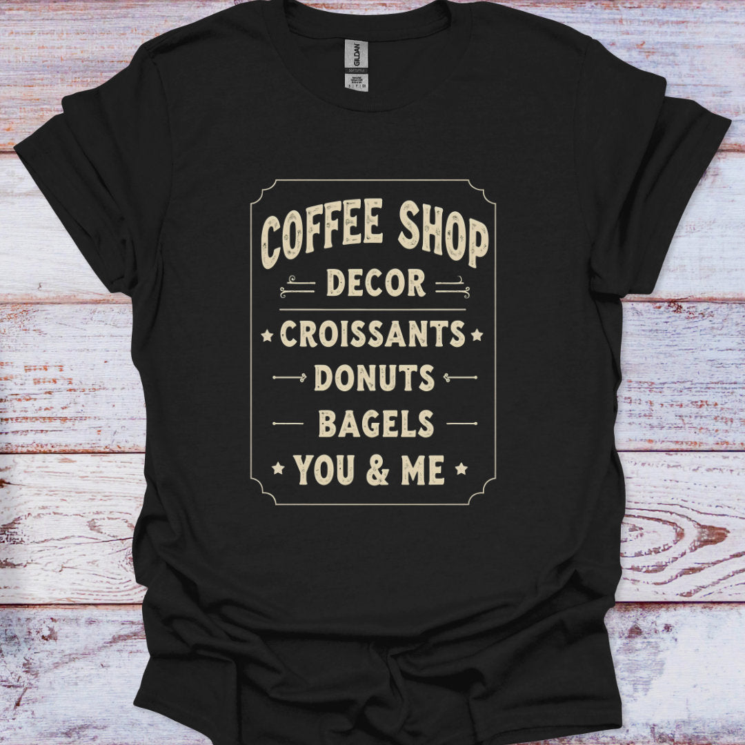 Black t-shirt with white text on a wooden surface