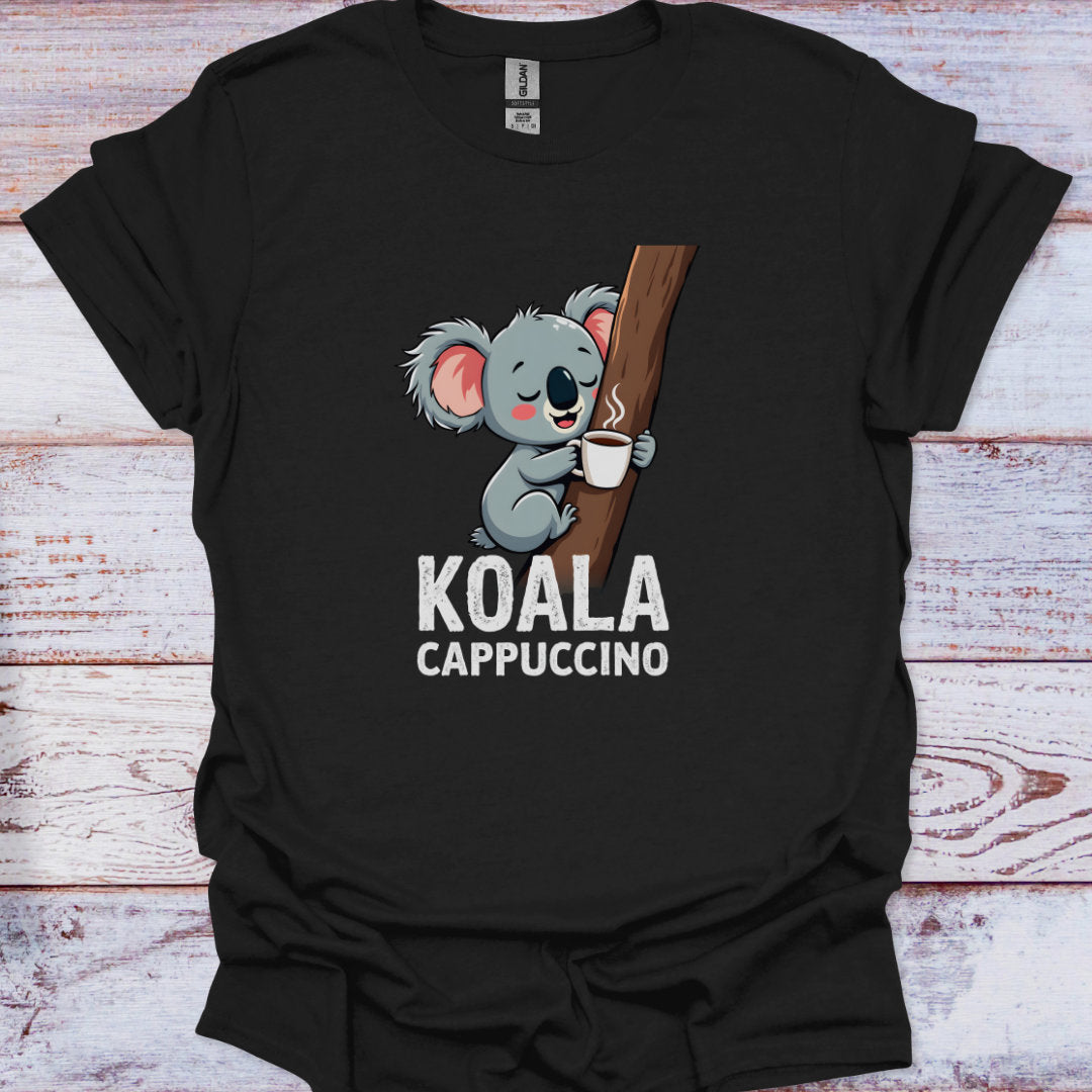Black t-shirt with a koala holding a coffee cup graphic and 'KOALA CAPPUCCINO' text on a wooden surface.