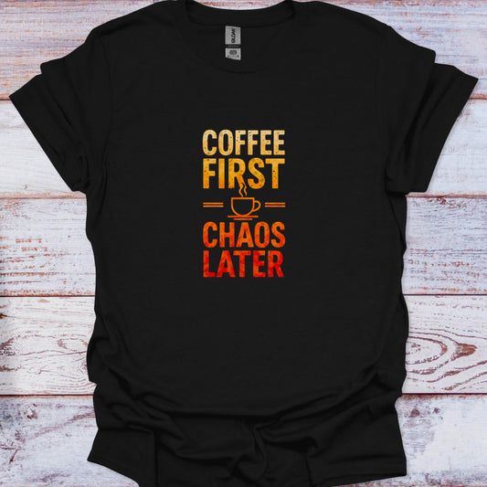 Distressed text graphic tee with a yellow-orange to red gradient reading 'COFFEE FIRST CHAOS LATER' split by a steaming cup icon, against a deep black background.