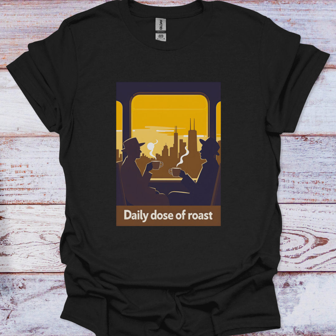 Black t-shirt with a graphic of two people in a car looking at a cityscape with 'Daily dose of roast' text on a wooden surface.