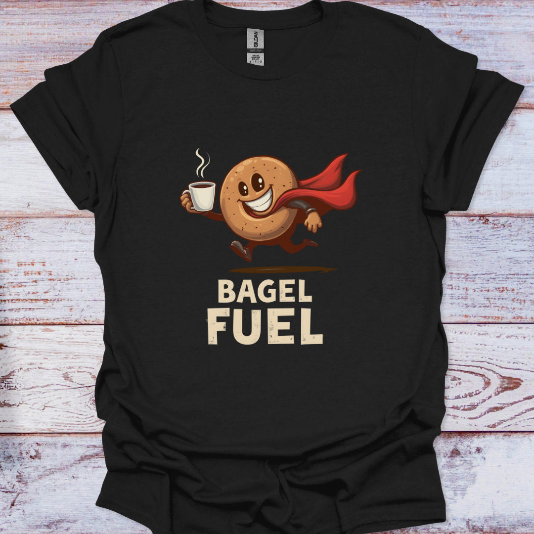 Black t-shirt with a bagel character holding a coffee cup and 'Bagel Fuel' text on a wooden surface