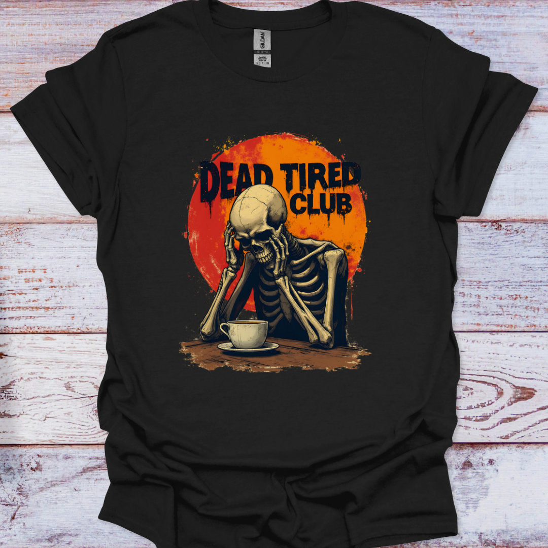 Black t-shirt with a skeleton and 'Dead Tired Club' graphic on a wooden surface